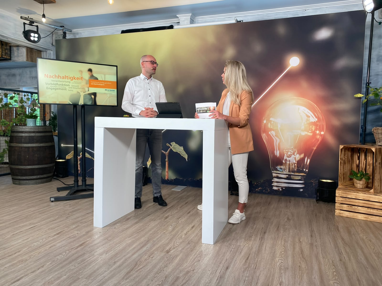 Dr. Ines Marbach im Gespräch mit einem Gast an einem Stehpult während einer digitalen Produktion.